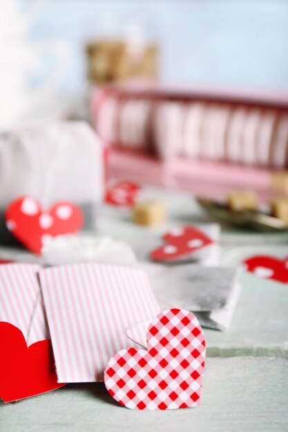 Heart shaped teabag tags and box on wooden background