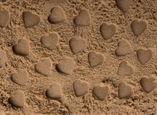 Heart shapes made on the sand background