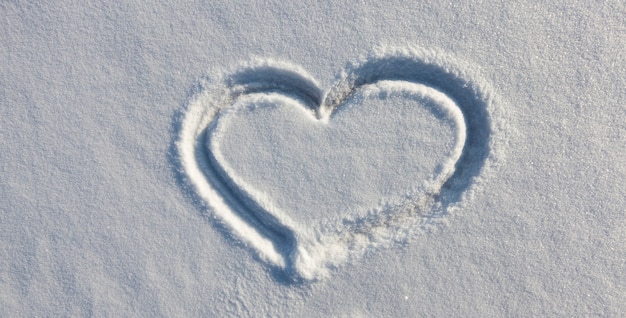 A heart symbol drawn on snow