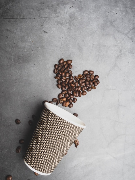 Photo heart symbol from coffee beans from a disposable paper cup