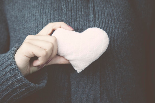 Heart on the woman hand in studio