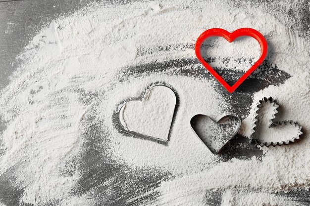 Hearts of flour on gray background