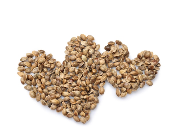 Hearts made of hemp seeds on white background