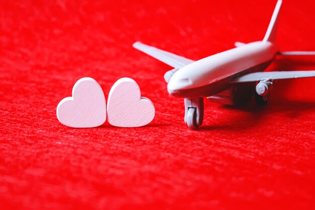 Hearts and a plane on a red background valentines day selective\
focus