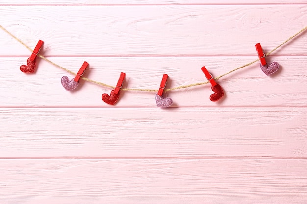 Hearts on a thread on a colored background