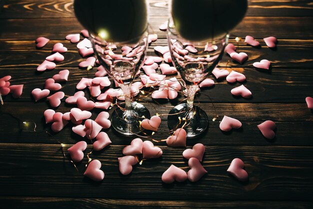 Hearts with wine glasses Romantics love concept Festive background Valentines day postcard Lights and lamps