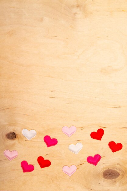 hearts on wooden background with copy space Greeting card with Lovefilled emotions on rustic timber