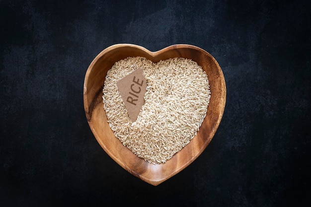 Heartshaped bowl with brown rice with copy space