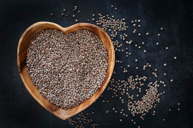 Heartshaped bowl with raw and dried lentils