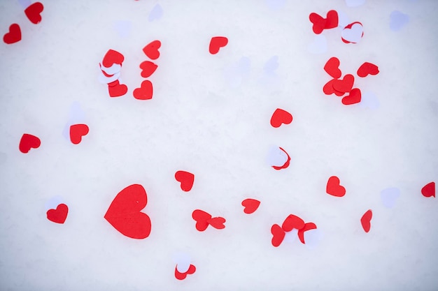 Heartshaped confetti lying on the snow