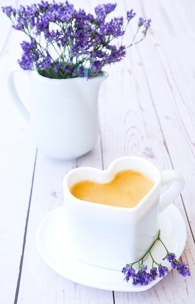 Heartshaped cup of aromatic freshly brewed coffee