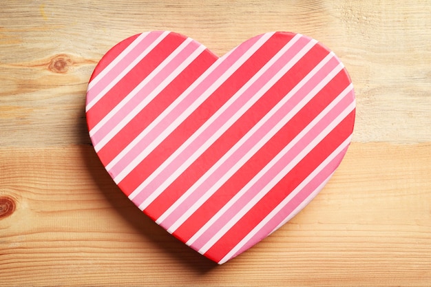 Heartshaped gift box on wooden background