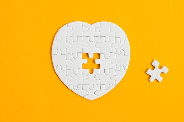 Heartshaped jigsaw puzzle on color background puzzle heart on color background