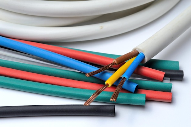 Heat shrink tubing and a three-core stripped wire on a white background.