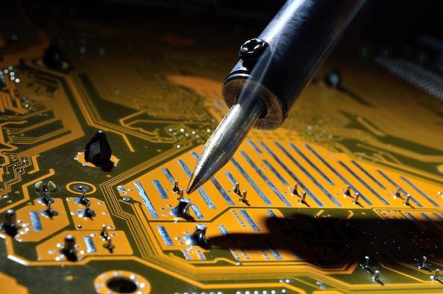 A heated soldering iron solders a small contact on the chip