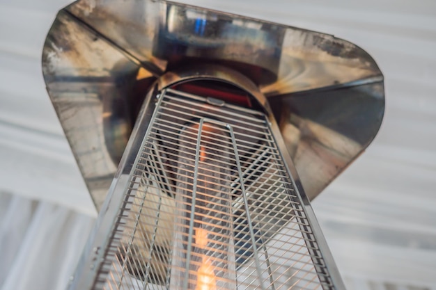 Heating lamp heater placed among the tables of an open cafe