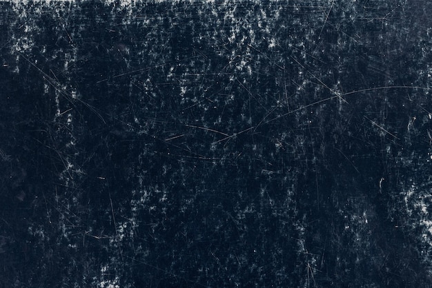 Heavily scratched dark blue surface flat full frame background and texture