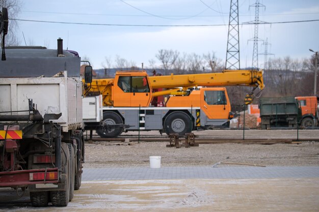 Heavy duty truck and mobile lifting crane at construction\
site