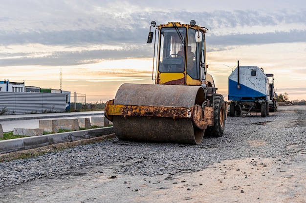 Heavy-duty vibratory roller for asphalt paving. Road construction. Construction of roads and urban transport communications. Heavy machinery.