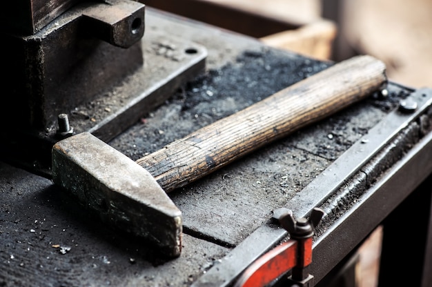 Heavy iron mallet or hammer on a workbench