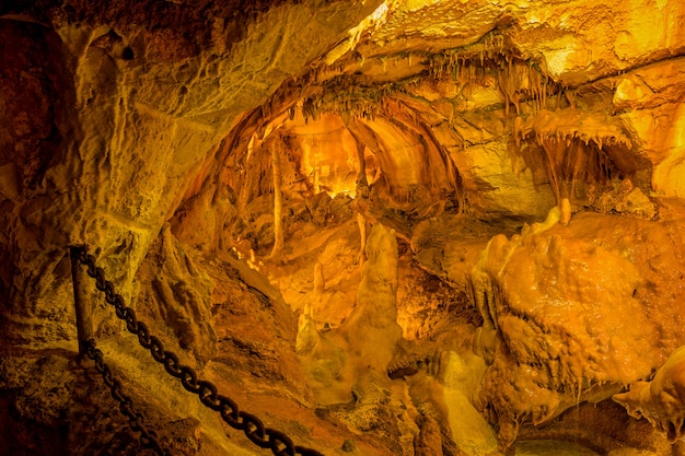 Heavy metal chain in caves da Moeda with stalactites and stalagmites.