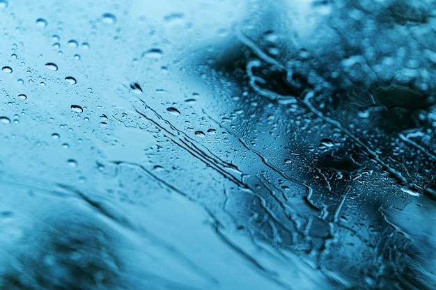 Heavy rain background, Raindrops on window glass outdoors 