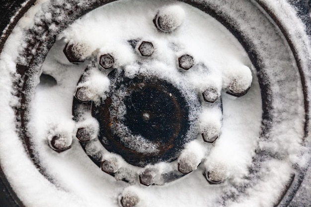 Heavy truck wheel covered with snow closeup