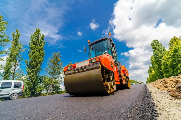 Heavy vibration roller at asphalt pavement works road\
repairing