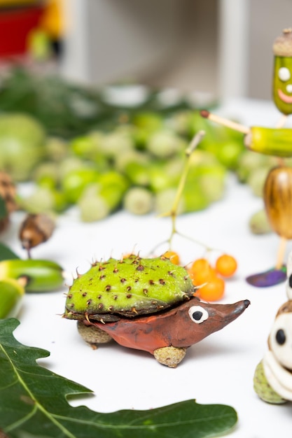 A hedgehog figurine made of plasticine and chestnut Autumn children's crafts