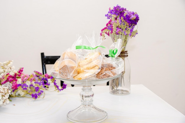 Foto heerlijk zoet brood in glas met bloemen op de achtergrond