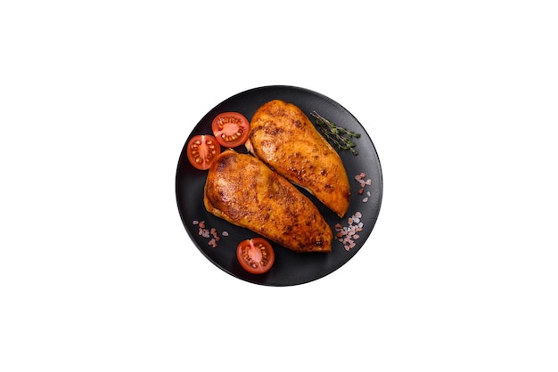 Heerlijke gegrilde kipfilet met specerijen en kruiden op een donkere betonnen ondergrond