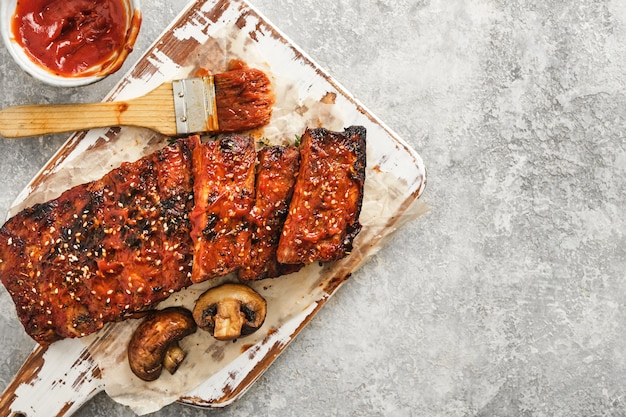 Heerlijke gegrilde ribben gekruid met een pittige rijssaus en geserveerd op een snijplank