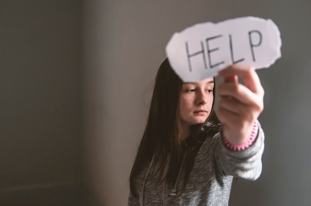 Foto hel, adolescente con il segno di aiuto