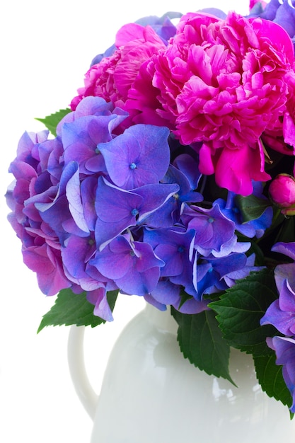 Helder roze pioenroos en blauwe hortensia verse bloemen boeket close-up geïsoleerd op wit