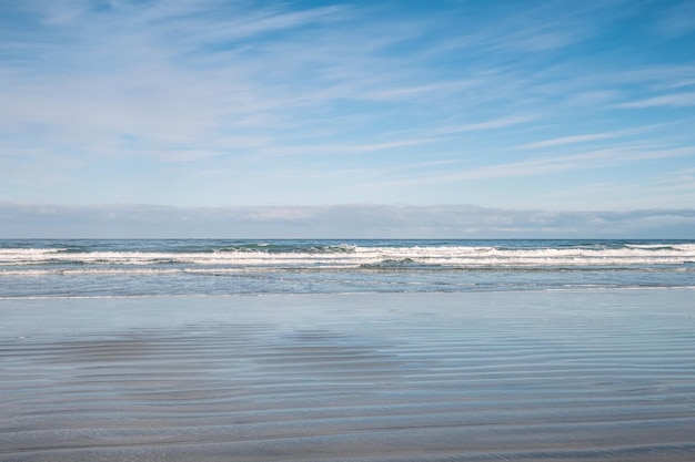 Heldere zee met golvend strand en golf