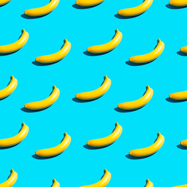 Heldergele bananen op een blauwe achtergrond. Naadloze patroon.
