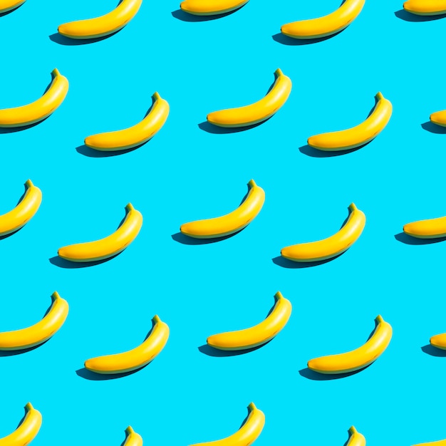 Heldergele bananen op een blauwe achtergrond. Naadloze patroon.