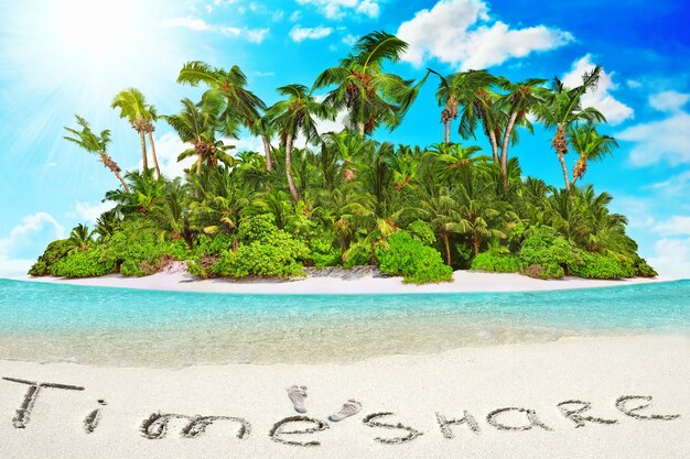 Hele tropisch eiland binnen atol in tropische Oceaan. Onbewoond en wild subtropisch eiland met palmbomen. Inscriptie "TimeShare" in het zand op een tropisch eiland, Malediven.