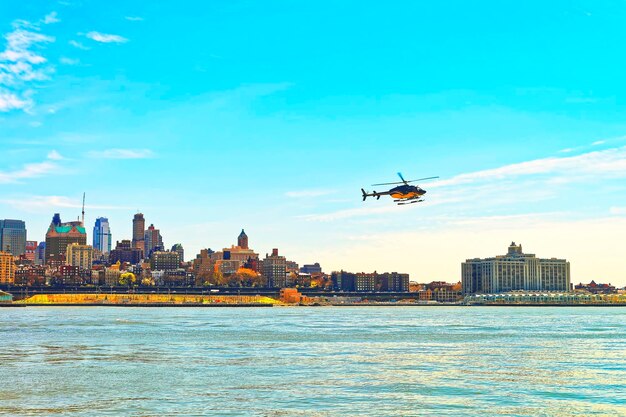 Helicopter above East River, New York, USA, East River. Skyscrapers of Brooklyn on the background.