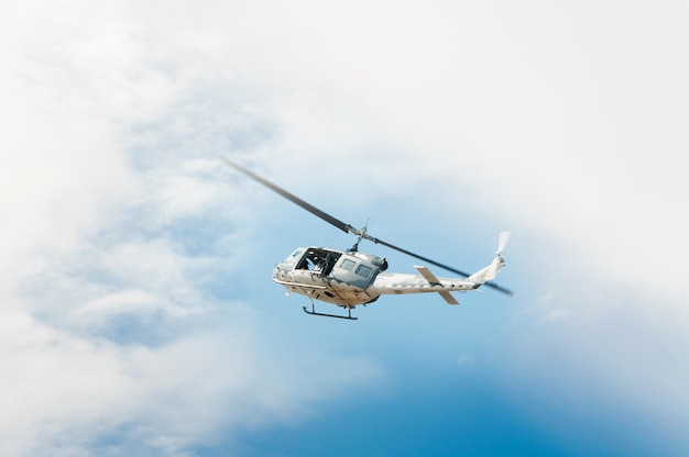 Helicopter in flight, blue sky background