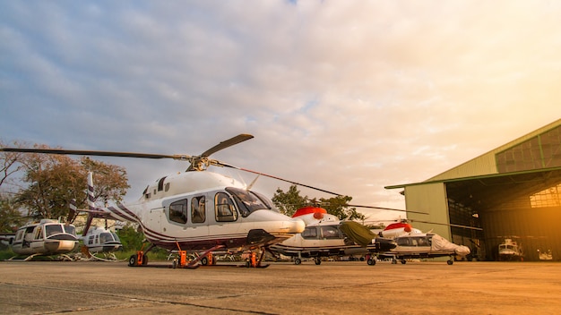 Helicopter in the parking lot or runway waiting for maintenance with sunrise background