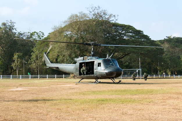 Helicopter soldier was landing on the lawn.