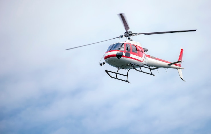Photo helicopter with red and white color fly in the sky