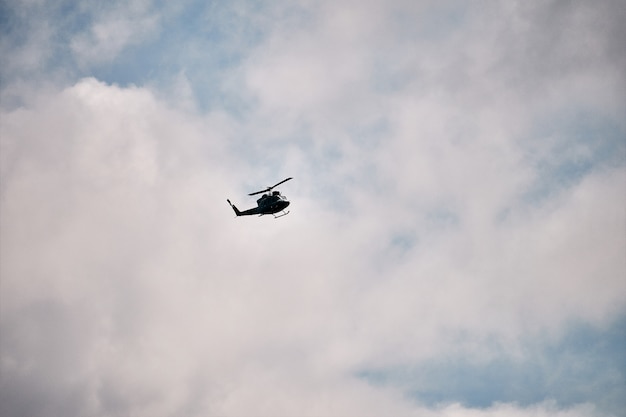 Foto helikopter die over de wolken vliegt