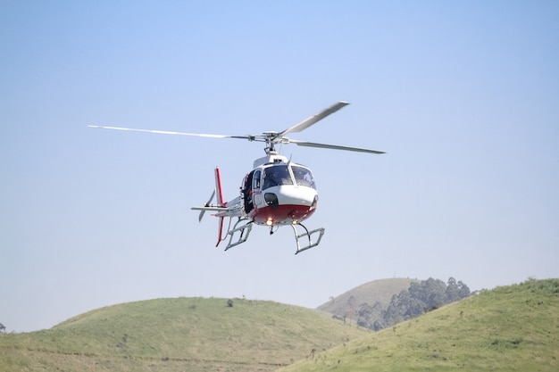 helikopter in de lucht die laag over de dam vliegt