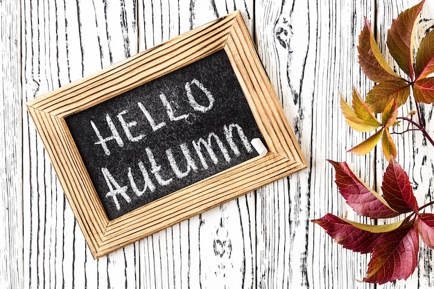 Hello autumn greeting text on chalkboard.