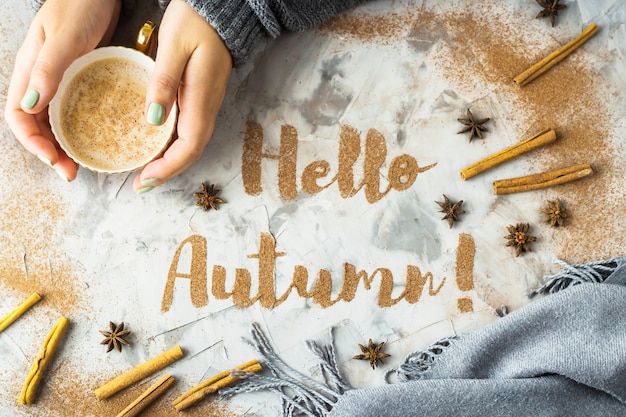 Hello, Autumn. The phrase is written with ground cinnamon on a gray background