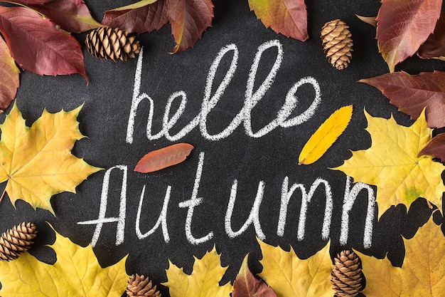 Photo hello autumn white chalk lettering on blackboard