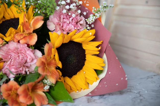 Ciao bellissimo bouquet autunnale con girasoli e garofani da vicino su sfondo chiaro biglietto di auguri per la composizione floristica stagionale