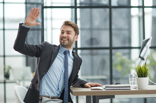 Hello by Man in Office Indoor Waving Hand